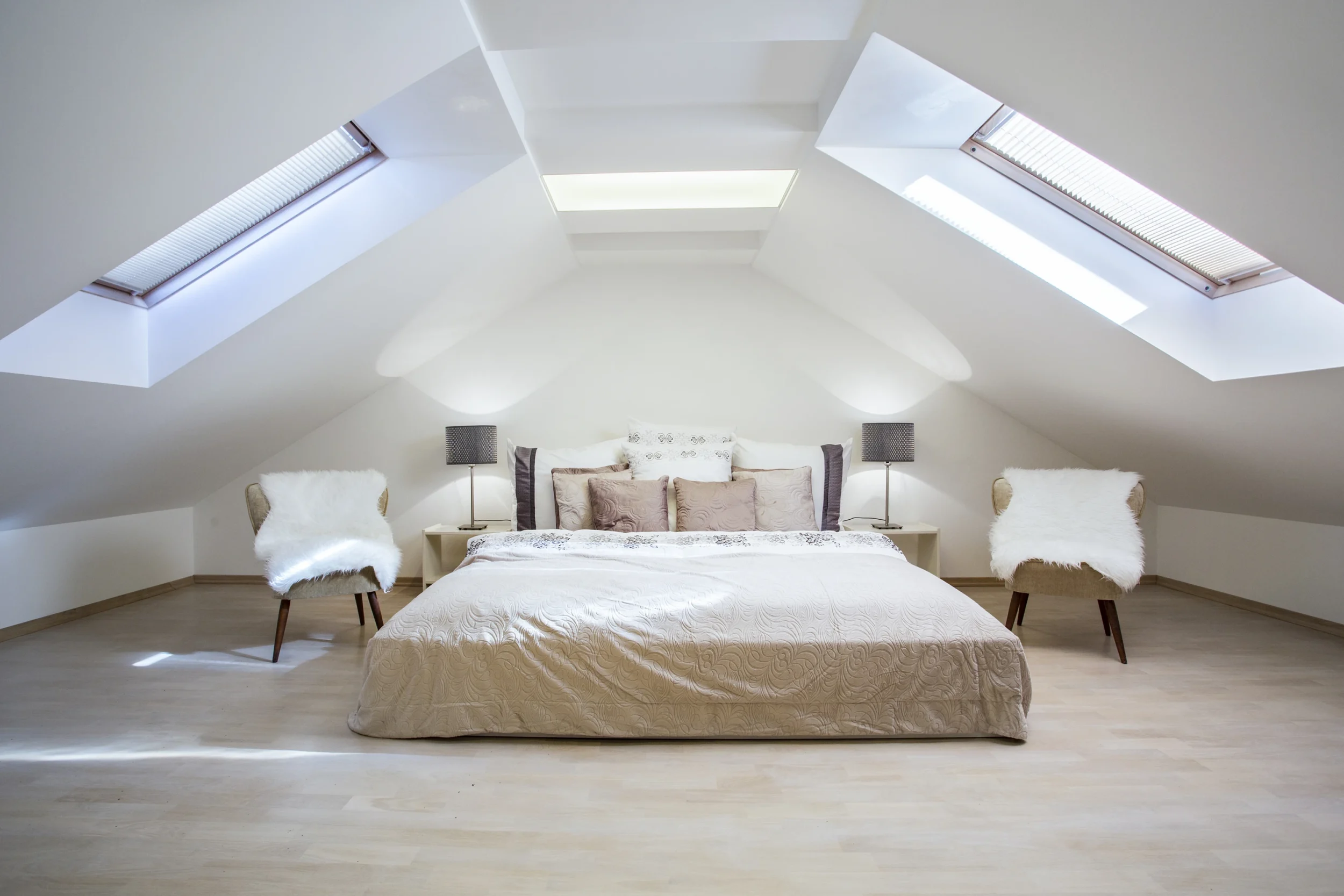 Converted loft bedroom with skylights completed by Renavo Build