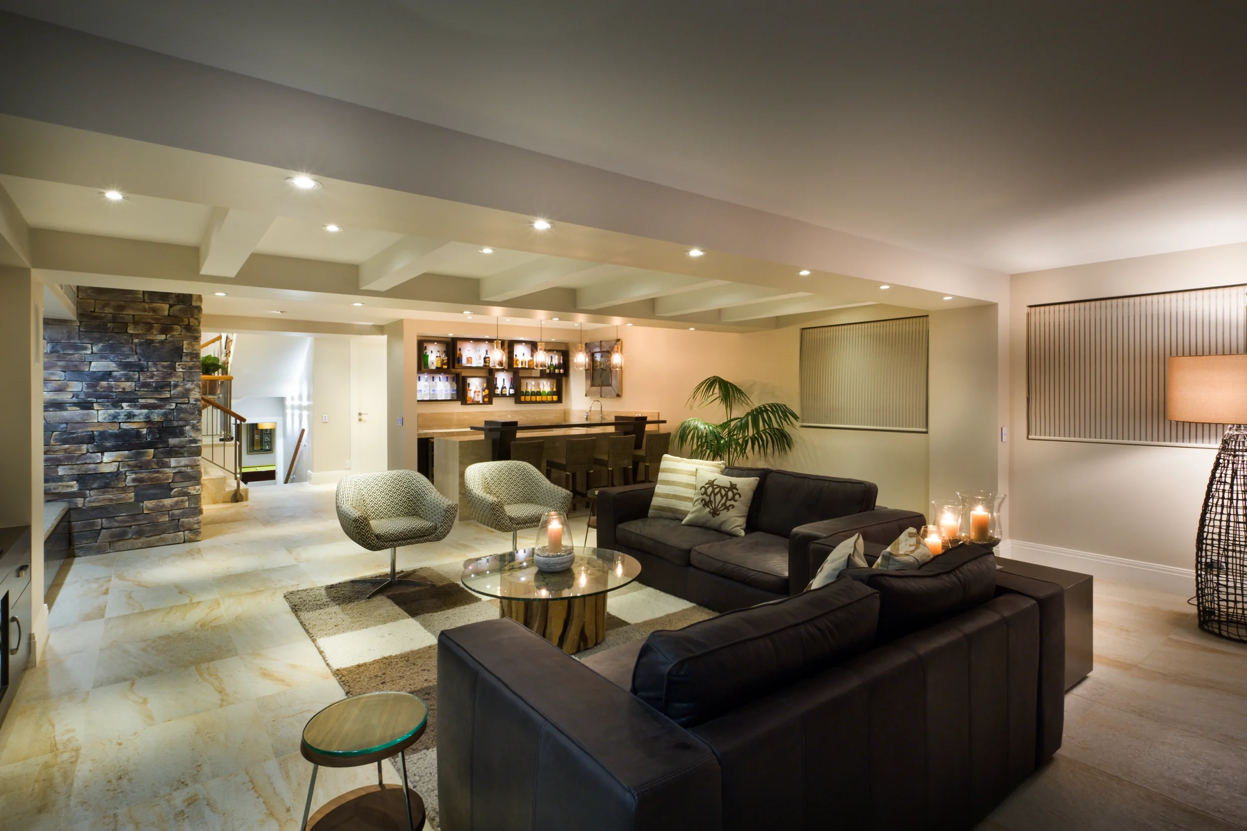 Luxury basement living area renovation with bar counter and lighting features