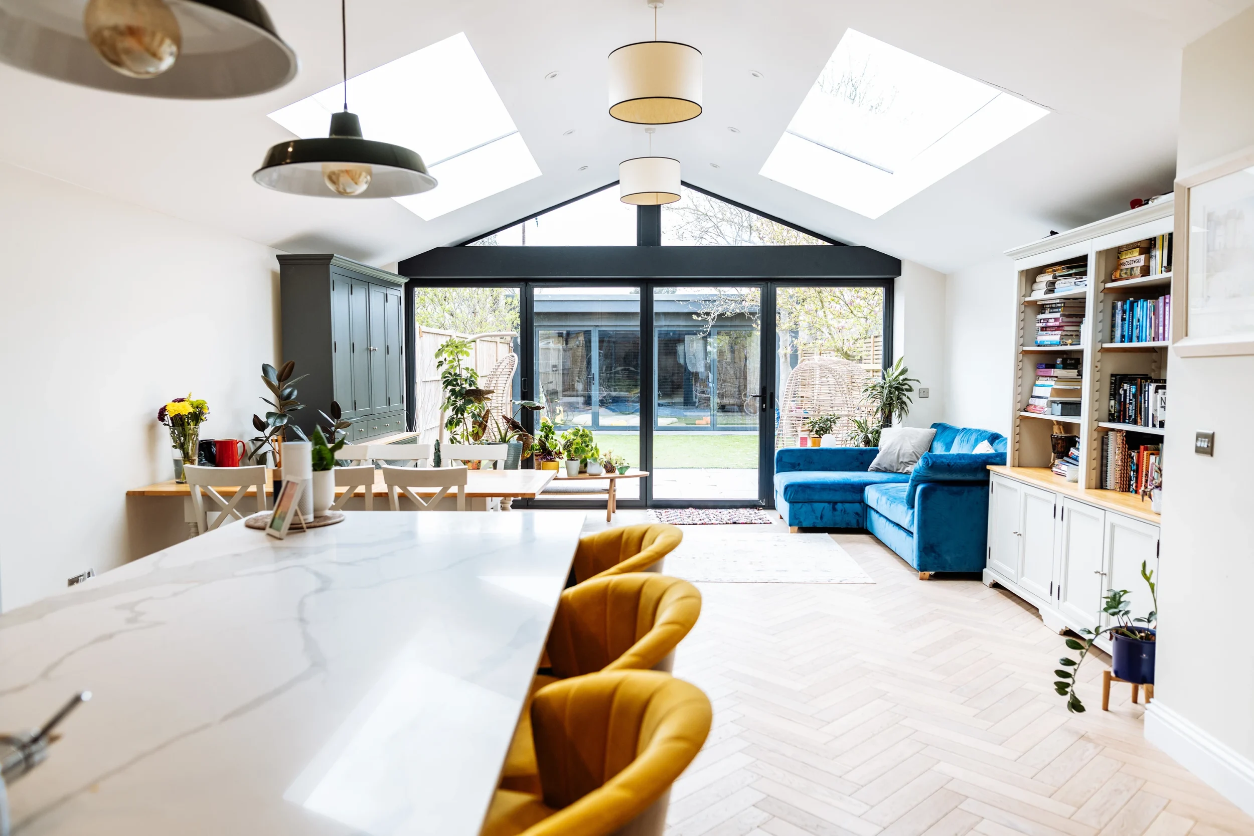 Contemporary kitchen and dining space with skylights and garden access by Renavo Build
