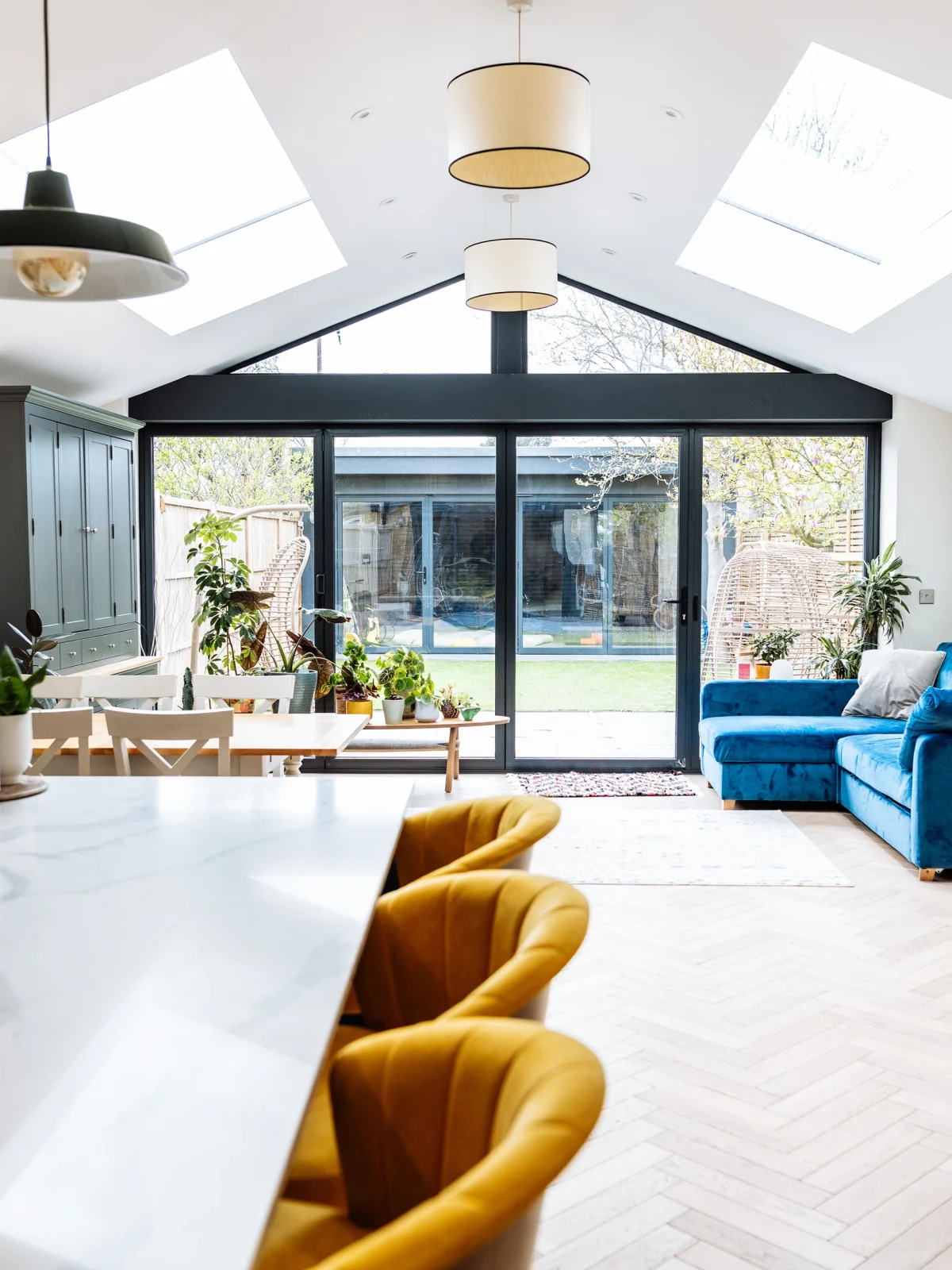 Contemporary kitchen and dining space with skylights and garden access by Renavo Build