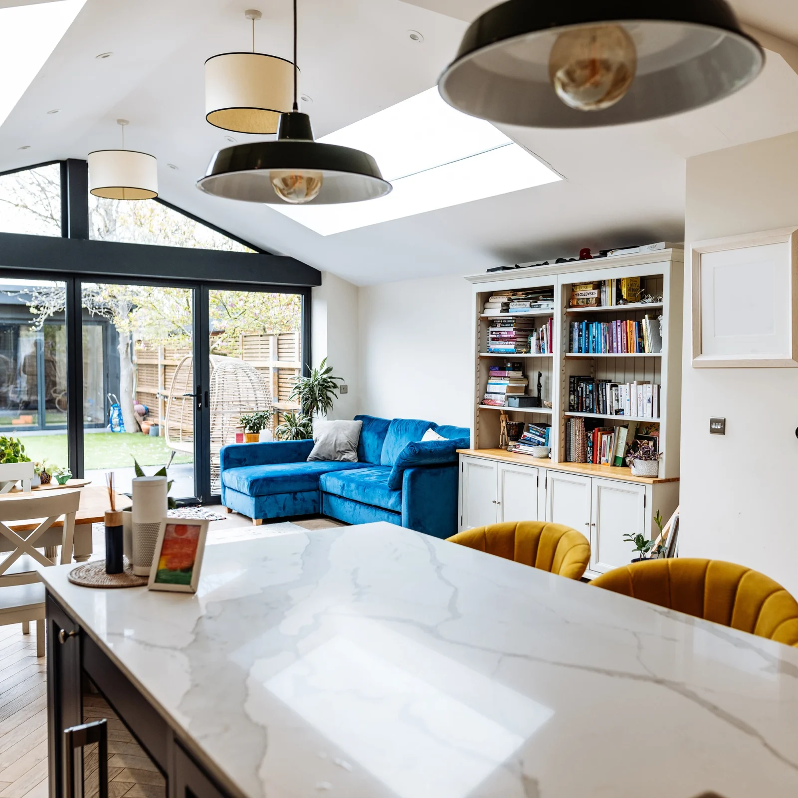 Open-plan kitchen extension with dining area and skylights by Renavo Build