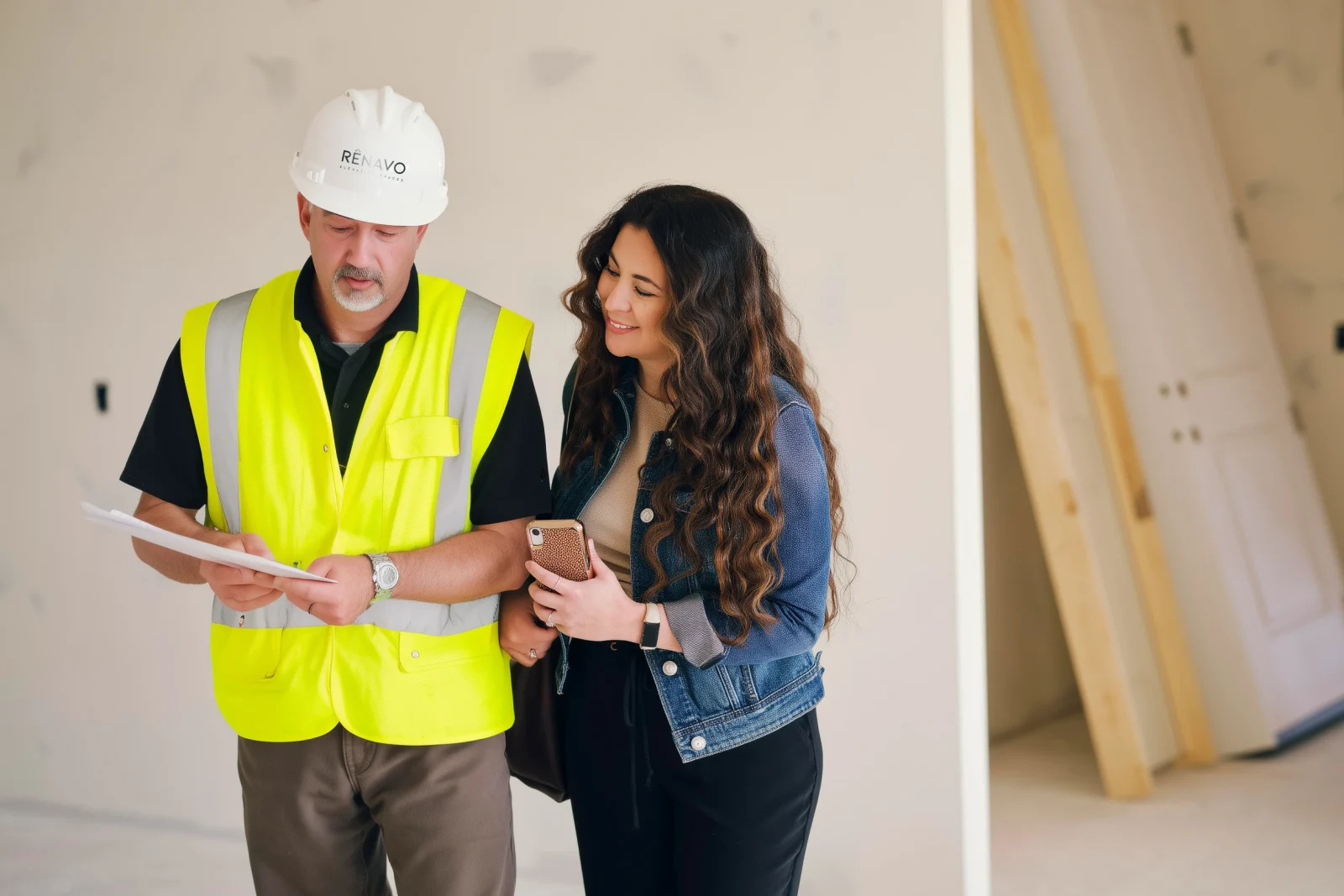 Construction manager from Renavo Build discussing plans with client