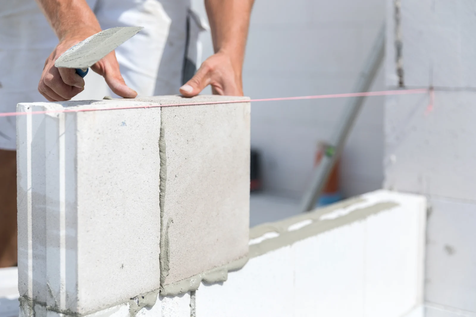 Renavo Build construction worker laying bricks for extension