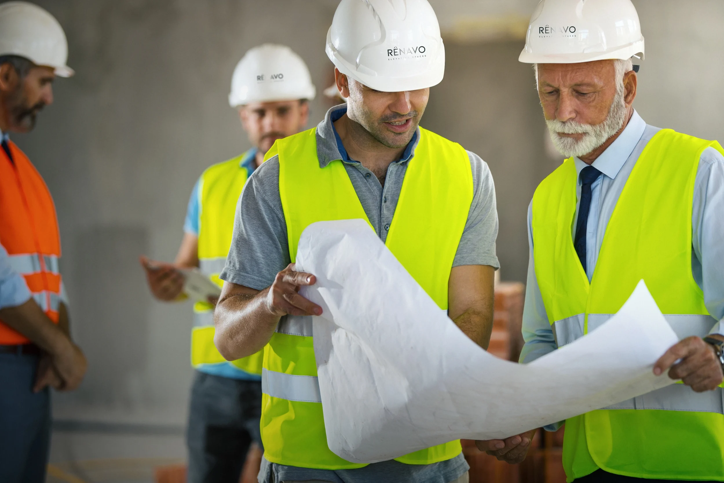 Team of Renavo Build engineers reviewing plans inside site office