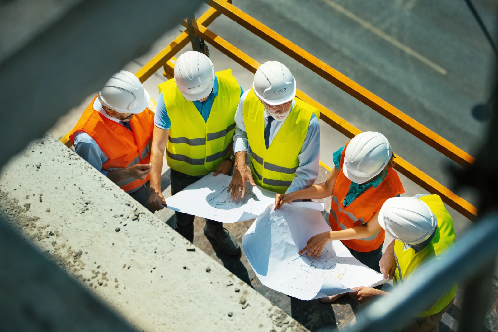 Renavo Build team reviewing plans on construction site
